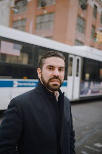 Photo of Rafael Espinal with buss behind him