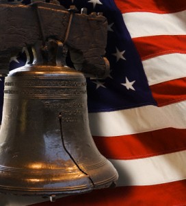 Liberty Bell with us flag behind image